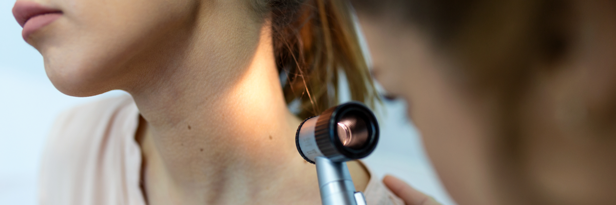 Image of dermatologist inspecting patient's skin